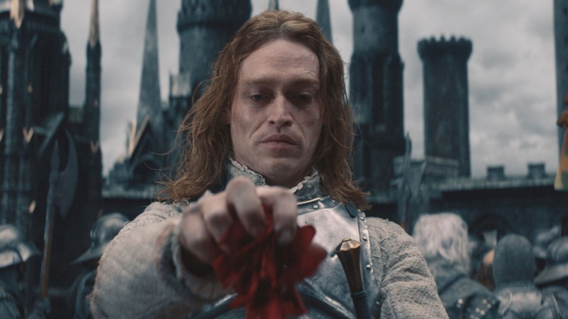 Caleb Landry Jones w makijażu wampira spogląda w dół z pogardą